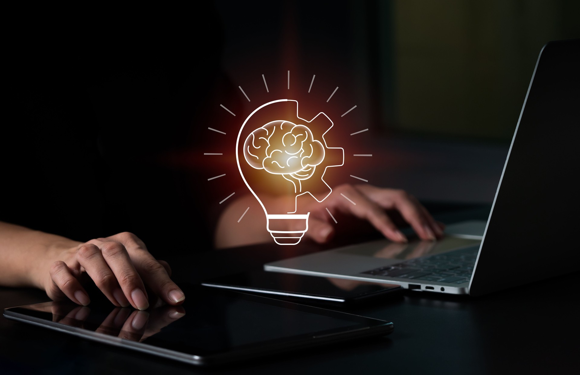 A businesswoman touches a digital tablet, and a bright light bulb appears on the screen. Ideas Concept for displaying fresh ideas New beginning with great creativity and inventiveness.