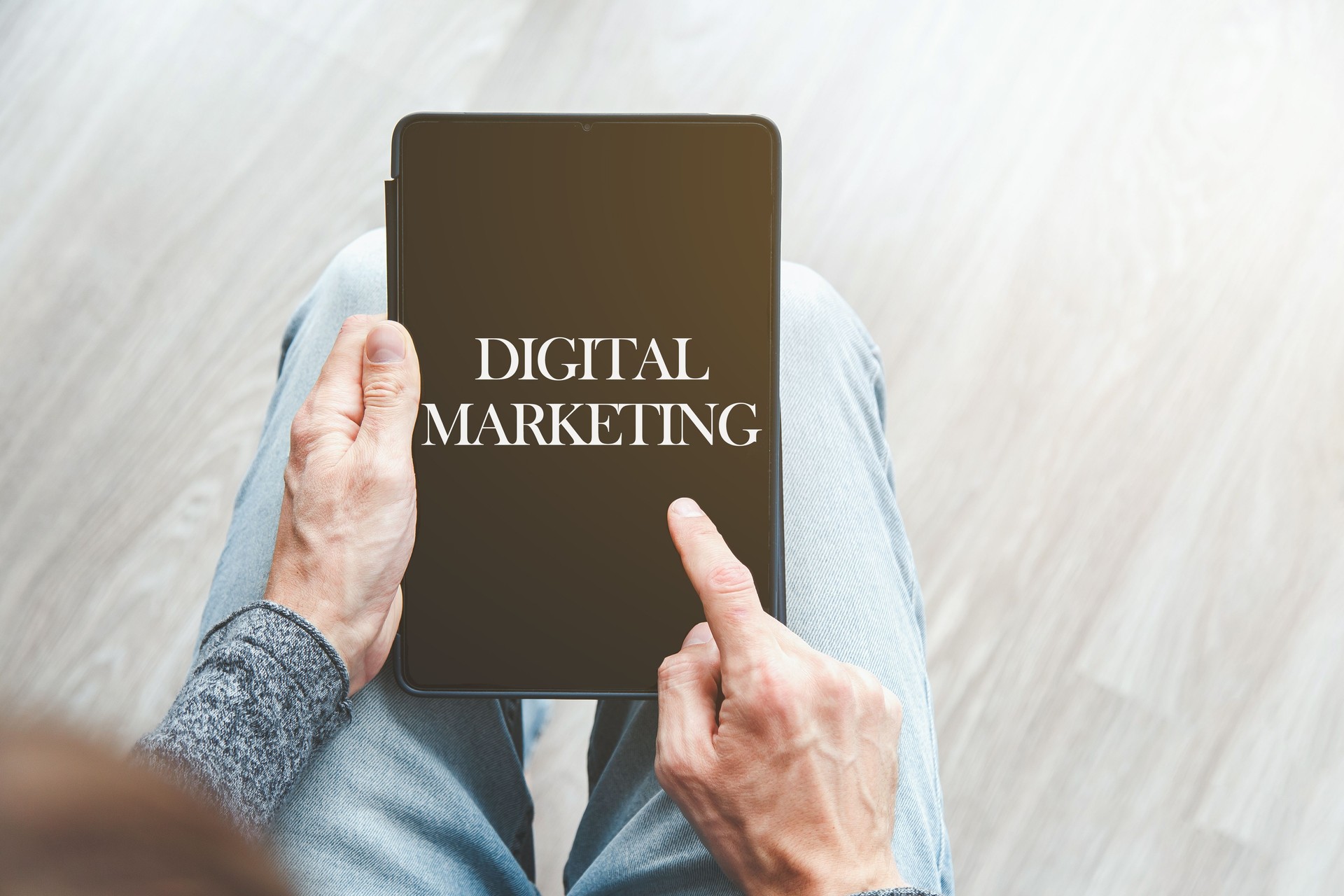 Man holding a tablet with the words text Digital Marketing on the screen, concept of online advertising and business strategy